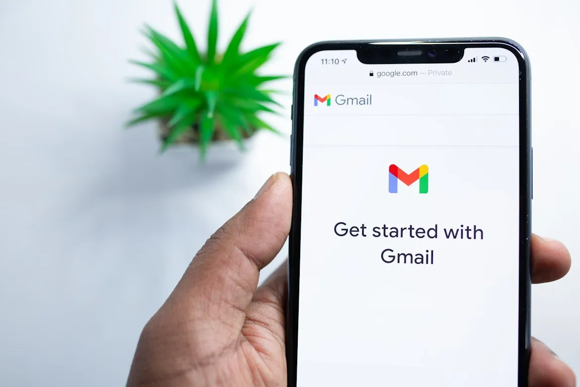 hand holding phone with gmail app